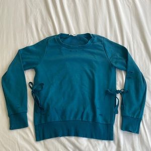 Distressed Turquoise Crew Neck with Side Slit Detail and Ties.